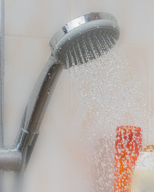 Shower head with running water for a natural hair girl on wash day